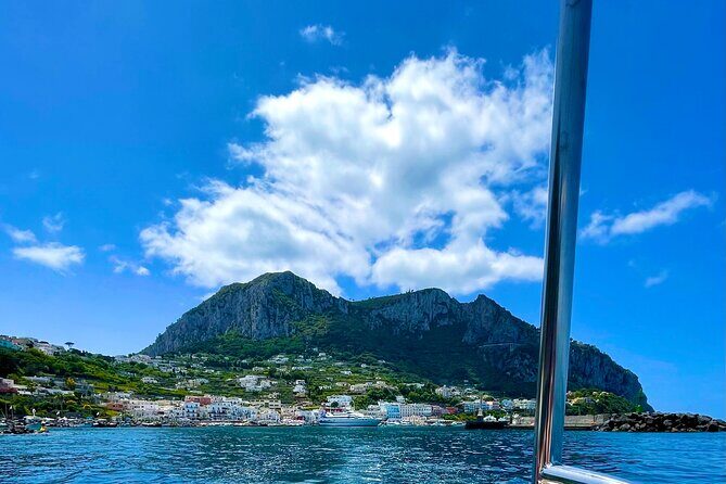 Boat Tour in Capri Italy - Faraglioni bay views, emerald reflections, and the lighthouse moment