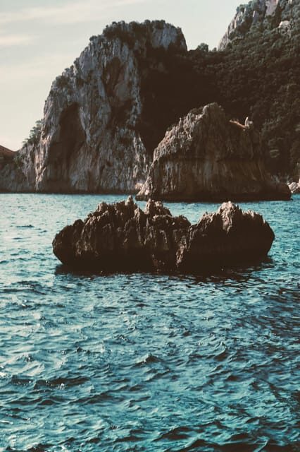 Positano: Capri and Blue Grotto Shared Boat Tour with Drinks - Cruising Capri’s coast: grottos, Faraglioni, and Punta Carena