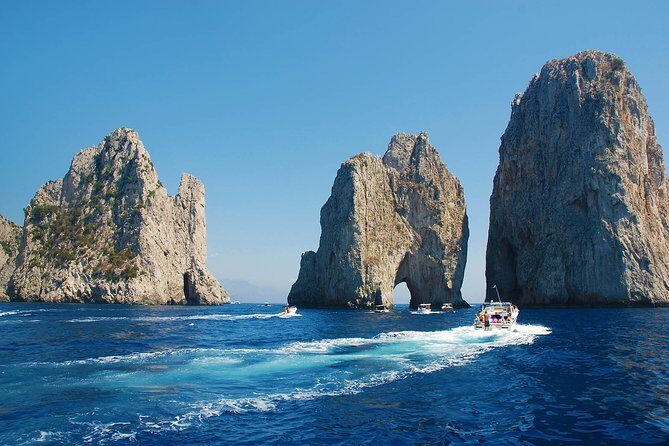 Small Group Boat Tour Capri & Blue Grotto with Swimming Stops - Capri landmarks from the boat: Faraglioni, Casa Malaparte, Punta Carena